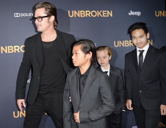 Actor Brad Pitt and children Pax Jolie-Pitt (L), Shiloh Jolie-Pitt (C) and Maddox Jolie-Pitt arrive for the U.S. premiere of Universal Pictures “Unbroken,” December 15, 2014 at the Dolby Theatre in Hollywood, California.   AFP PHOTO / ROBYN BECK        (Photo credit should read ROBYN BECK/AFP/Getty Images)