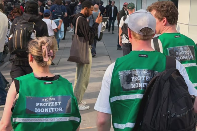 NYC Department of Investigations monitors marching alongside protesters in Manhattan Tuesday.