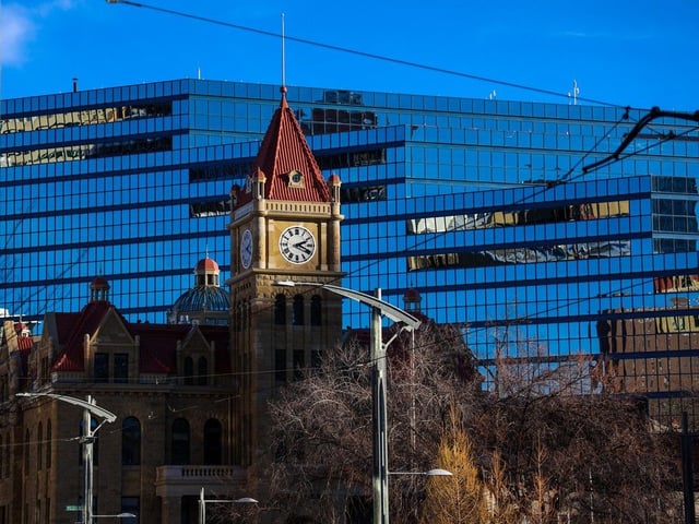 Calgary's old city hall is framed against the newer municipal building on Monday, Nov. 21, 2022.
