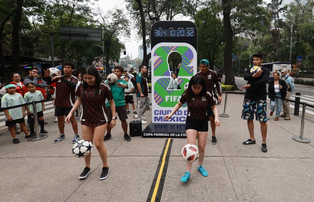 Soccer Football - World Cup - Mexico holds event to mark one year to go until the World Cup - Paseo de la Reforma Avenue, Mexico City, Mexico - June 11, 2025 Performers play with footballs during the countdown clock presentation on Reforma Avenue REUTERS/Henry Romero