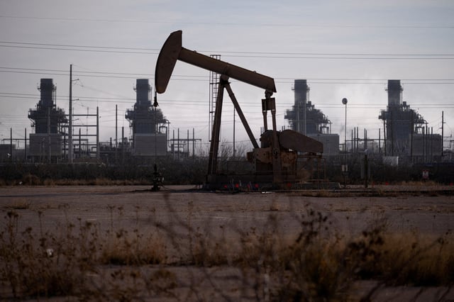 A pump jack operates near a gas turbine power plant in the Permian Basin oil field outside of Odessa, Texas, U.S. February 18, 2025.  REUTERS/Eli Hartman/File Photo