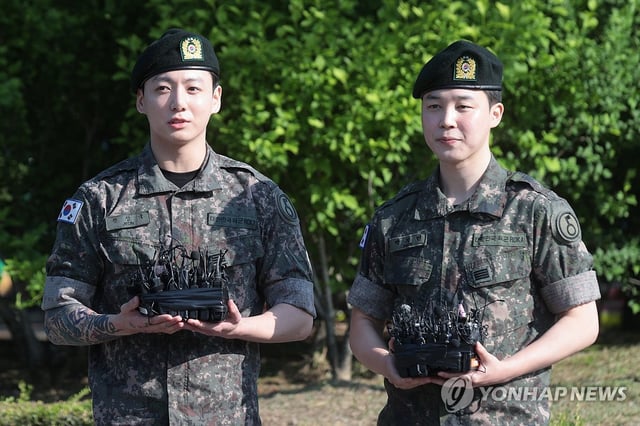 BTS' Jungkook (L) and Jimin speak to the press during a brief ceremony at a public sports facility in Yeoncheon, some 60 kilometers north of Seoul, to mark their discharge from the South Korean military on June 11, 2025. (Yonhap)