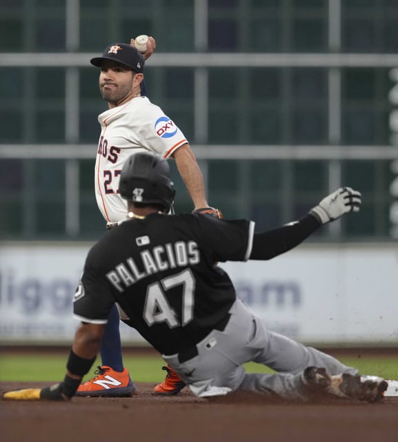 Houston Astros second baseman Jose Altuve (27) turns a double play as Chicago White Sox outfielder Joshua Palacios slide in in the second inning of an MLB baseball game in Houston, Wednesday, June 11, 2025.