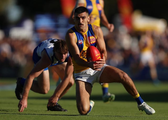 West Coast defender Tom Cole.