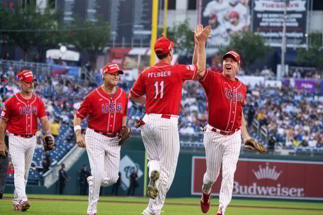 Rep. August Pfluger, R-Texas, is congratulated by Sen. Eric Schmitt, R-Mo., after a play in the first inning of the Congressional Baseball Game at Nationals Park on Wednesday.