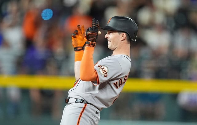 San Francisco Giants’ Mike Yastrzemski gestures to the dugout after he reached second base on an double that drove in two runs off Colorado Rockies relief pitcher Tyler Kinley in the eighth inning of a baseball game Wednesday, June 11, 2025, in Denver. (AP Photo/David Zalubowski)