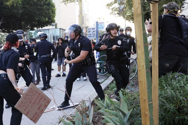 Los Angeles police officers arrest demonstrators after giving an order to disperse, during a protest in response to a series of  U.S. Immigration and Customs Enforcement (ICE) raids throughout the country in Los Angeles, Calif., on Wednesday, June 11th, 2025.