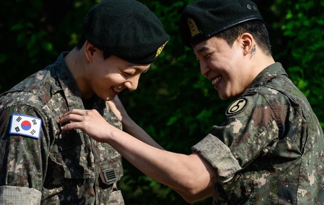 Jungkook (left) and Jimin share a happy moment shortly after their release from 18 months of South Korean military service on Wednesday. Photo: AFP