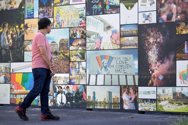 A visitor views photos at the Pulse Interim Memorial in Orlando, Florida, on June 12, 2023 — the seventh anniversary of the date when a gunman opened fire on the crowd at the Pulse nightclub, killing 49 people.