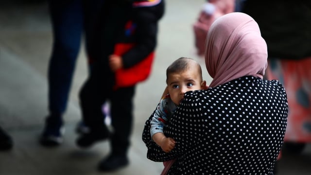 A mother carriers her baby during celebrations for Eid al-Adha at Trafalgar Square in June 2025 in London, U.K. A new UNFPA report warns that as global fertility rates are declining, very high proportions of men and women in every region of the world are unable to achieve their fertility aspirations.