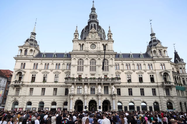 People attend a memorial service at a main square in Graz, following a deadly shooting at a secondary school, Austria, June 11, 2025.  REUTERS/Leonhard Foeger