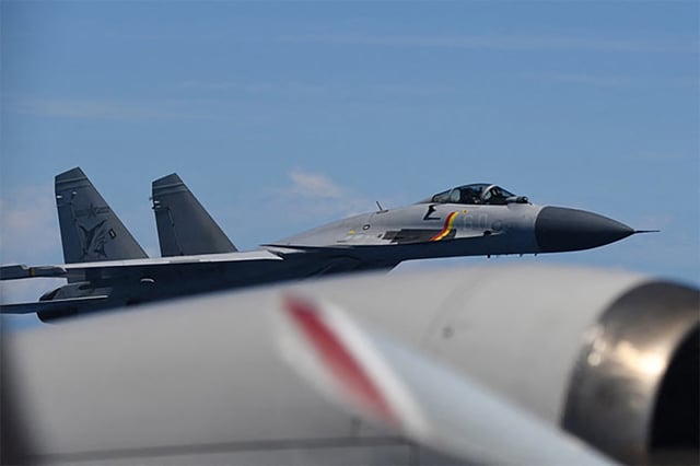 This handout photo taken on June 8, 2025 and received on June 12, 2025 from Japan's Ministry of Defence shows a J-15 fighter jet from the Chinese aircraft carrier Shandong making an unusual approach to a Japan Maritime Self-Defence Force P-3C patrol aircraft that was conducting surveillance above the Pacific Ocean.