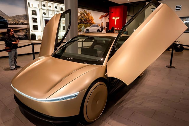 A Tesla Cybercab prototype. Tesla CEO Elon Musk said this version of the robotaxi, which has no steering wheel or pedals, will "probably" will go into production in 2026. The Tesla robotaxi service due to start later this month will use Model Y SUVs already on the market.