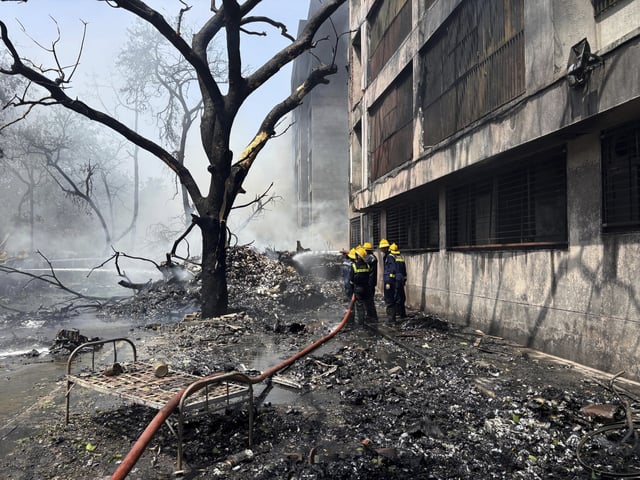 Firefighters work at the site of an airplane that crashed in India's northwestern city of Ahmedabad in Gujarat state, Thursday, June 12, 2025. (AP Photo/Ajit Solanki)