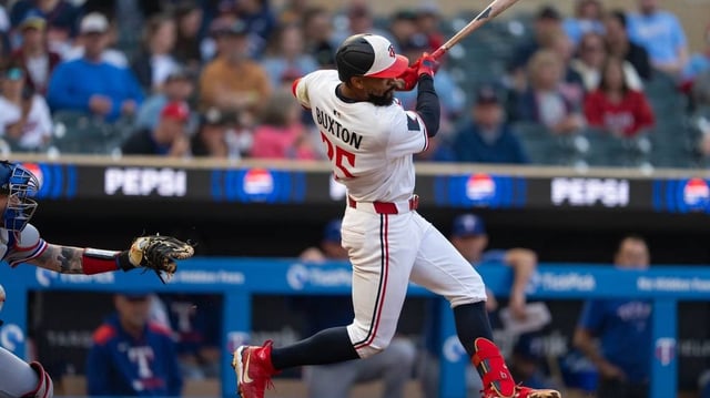 Jun 11, 2025; Minneapolis, Minnesota, USA; Minnesota Twins center fielder Byron Buxton (25) hits a double during the fifth inning against the Texas Rangers at Target Field. Mandatory Credit: Jordan Johnson-Imagn Images
