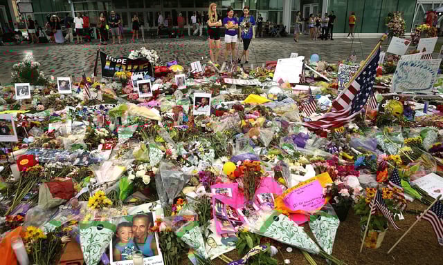 Hundreds of flowers and tributes to those killed in the Pulse Nightclub shooting. (Getty)