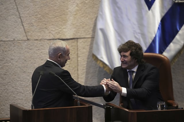Israel's Prime Minister Benjamin Netanyahu, left, greets Argentina's President Javier Milei in the Knesset, Israel's parliament, in Jerusalem, Wednesday, June 11, 2025. (AP Photo/Ohad Zwigenberg)
