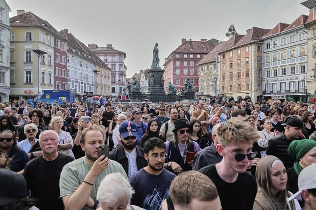People attend a wreath laying ceremony after a former student opened fire the day before fatally wounding several people and injuring many others before taking his own life, Graz, Austria, Wednesday, June 11, 2025. (AP Photo/Darko Bandic)