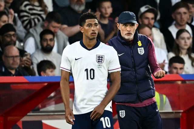 England's head coach Thomas Tuchel, right, speaks to midfielder Jude Bellingham as he prepares to enter the pitch during the international friendly football match between England and Senegal at the City Ground stadium, in Nottingham, England, on June 10, 2025.