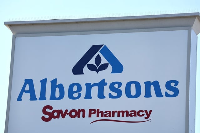 A judge blocked Kroger Co.’s $24.6 billion acquisition of Albertsons Cos., finding the takeover would lessen competition for US grocery shoppers, in a ruling that marks a likely death knell for the deal. The Albertsons logo is displayed at an Albertsons supermarket on Aug. 26, 2024 in Los Angeles.  (Photo by Mario Tama/Getty Images)