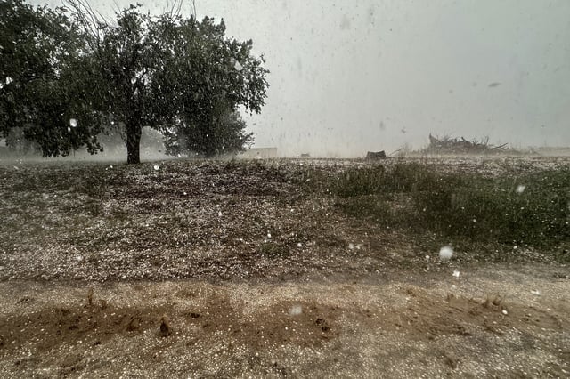 A hailstorm is visible from Northern Illinois University's Husky Hail Hunter vehicle during a Project ICECHIP operation Friday, June 6, 2025, in Levelland, Texas. (AP Photo/Carolyn Kaster)
