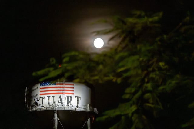 A full strawberry moon rises near the Stuart Water Tower in Stuart, Florida, on Wednesday, June 11, 2025.