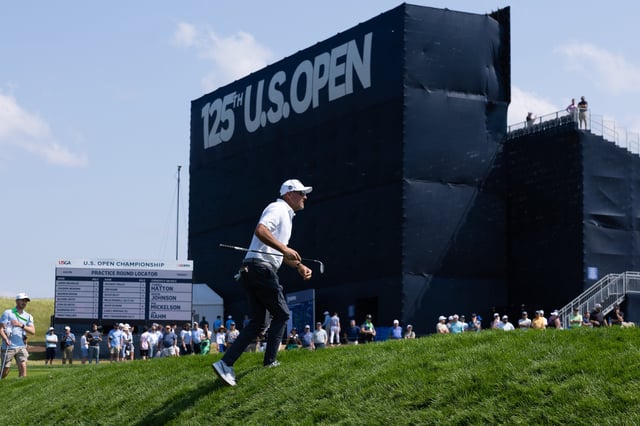 Phil Mickelson walks up a slope onto the on the 16th green during a practice round for the U.S. Open golf tournament at Oakmont Country Club.