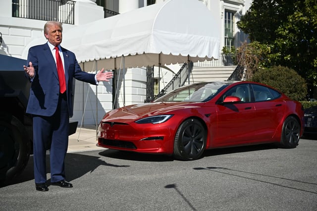 President Donald Trump speaks to the press as he stands next to a Tesla vehicle on the South Portico of the White House on March 11, 2025 in Washington, DC.