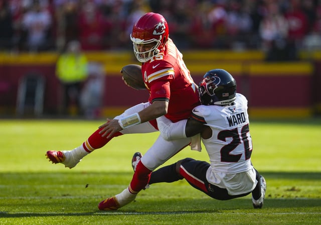 Dec 21, 2024; Kansas City, Missouri, USA; Kansas City Chiefs quarterback Patrick Mahomes (15) is tackled by Houston Texans safety Jimmie Ward (20) during the first half at GEHA Field at Arrowhead Stadium. Mandatory Credit: Jay Biggerstaff-Imagn Images/File Photo