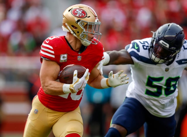 San Francisco 49ers’ Christian McCaffrey (23) runs against Seattle Seahawks’ Derick Hall (58) in the first quarter at Levi’s Stadium in Santa Clara, Calif., on Sunday, Nov. 17, 2024. (Nhat V. Meyer/Bay Area News Group)