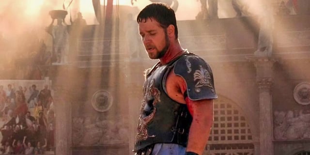 Maximus standing in the arena with the sunlight above him in Gladiator.