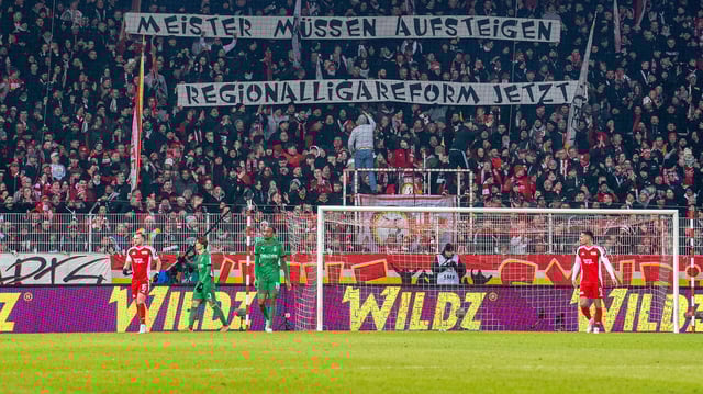 Fans von Union mit Transparent: Meister müssen aufsteigen - Regionalligareform jetzt.