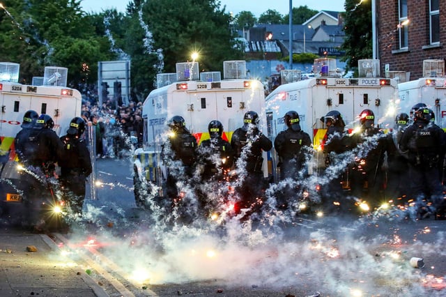 Fireworks thrown at Riot Police illluminate the road during a thrid night of anti-immigration demonstrations in Ballymena, Northern Ireland, on June 11, 2025. 