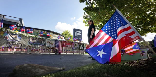 Orlando resident Jakob Strawn reflects on the scene at the Pulse nightclub shooting site in Orlando on the 9th anniversary of the 2016 massacre that killed 49, Thursday, June 12, 2025.  (Joe Burbank/Orlando Sentinel)