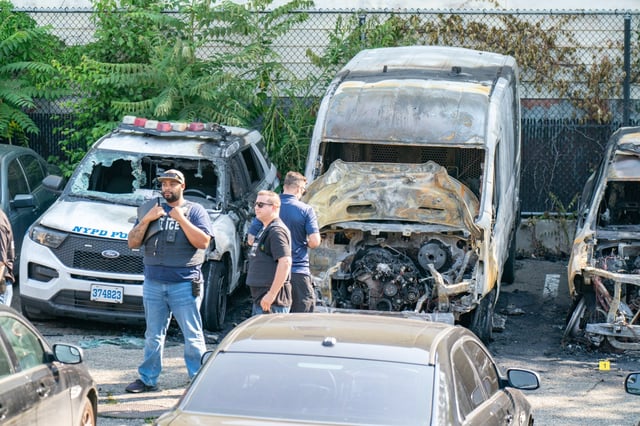 Eight NYPD vehicles were burnt after an arsonist set them on fire while they were parked in a parking lot bounded by Central Ave. and Dekalb Ave. in Brooklyn on Thursday, June 12, 2025. (Theodore Parisienne / New York Daily News)