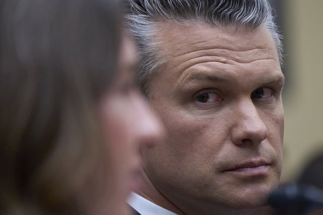 Secretary of Defense Pete Hegseth looks at Bryn MacDonnell, left, acting chief financial officer at the Department of Defense, as he fields questions on the Pentagon budget from the House Armed Services Committee, at the Capitol in Washington, Thursday, June 12, 2025. (AP Photo/J. Scott Applewhite)