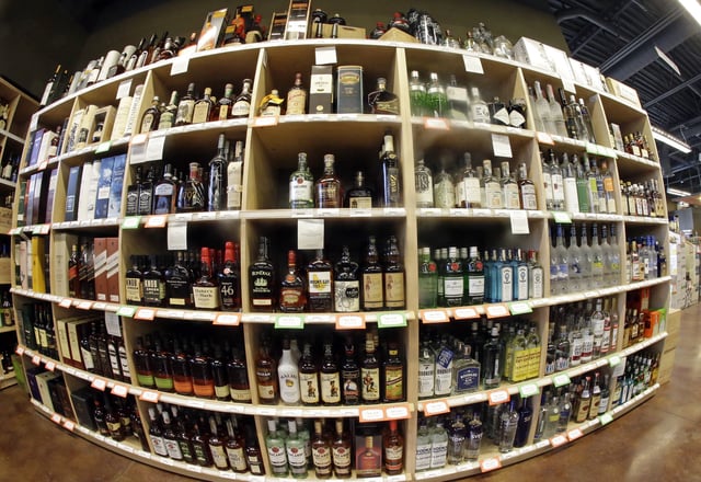 In this image taken with a fisheye lens, bottles of alcohol are displayed during a tour of a state liquor store Thursday, June 16, 2016, in Salt Lake City. Utah lawmakers toured a state liquor store and warehouse as critics say Utah's alcohol control agency needs more money and stores to meet the demand from residents. (AP Photo/Rick Bowmer)