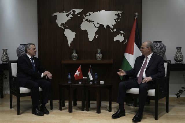 Swiss Federal Councillor Ignazio Cassis, left, meets with Palestinian Prime Minister Mohammad Mustafa, right, in the West Bank city of Ramallah, Wednesday, June 11, 2025. (AP Photo/Majdi Mohammed)