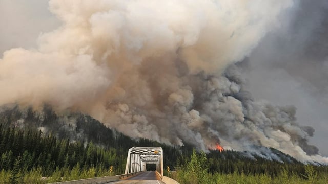 Smoke rises from the Summit Lake wildfire, west of Fort Nelson, B.C., on June 3. Federal officials say this season is on track to become Canada's second-worst wildfire season.