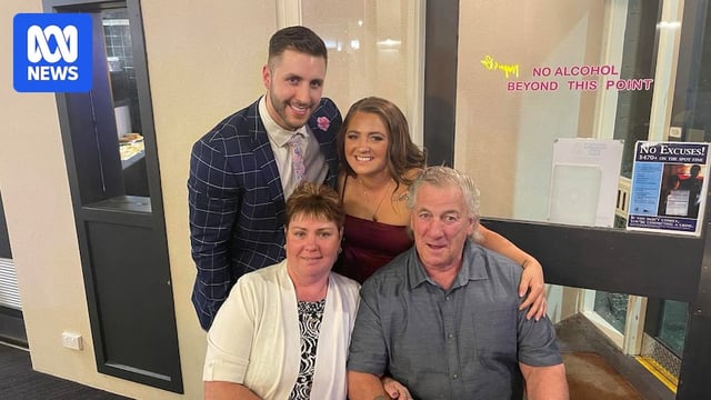 Four people sit close together as they pose for a picture.