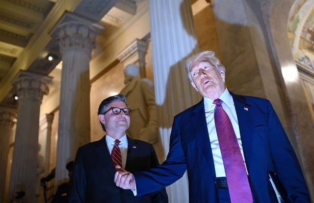 President Donald Trump stops to speak to media members while standing next to Speaker of the House Mike Johnson as Trump arrives at the United States Capitol to attend the House Republican Conference on May 20, 2025, in Arlington, Virginia.