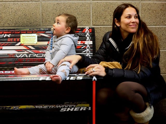  Johnny Gaudreau’s widow, Meredith. with their son Johnny Jr., check out the first commemorative bench made of hockey sticks unveiled at the Flames Community arena in Calgary on December 2, 2024.