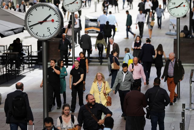 People walk through the financial district of Canary Wharf, London, Britain, 28 September, 2017. REUTERS/Afolabi Sotunde/File Photo