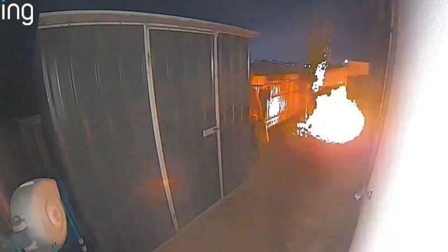 A ring camera at the Dover Street house also captures the moment the house is engulfed, before two men, one carrying what appears to be a jerry can, flee the scene. (Source: Victoria Police)