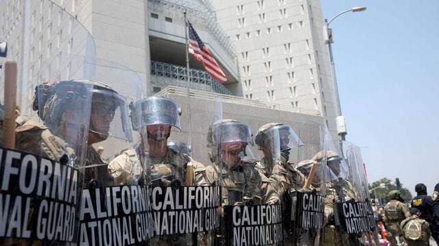 National Guard troops stand outside the Metropolitan Detention Center in Los Angeles on Sunday, part of a controversial federal deployment ordered by President Donald Trump amid statewide protests over immigration raids.