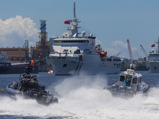 Coast Guard Special Task Unit (STU), an elite unit within the Taiwanese Coast Guard Administration, responsible for high-risk operations like counter-terrorism, anti-smuggling, and air-sea rescue, prepare to board a "hijacked" vessel taking part in the "Sea Safety No.12" exercises during a maritime drill in Kaohsiung on June 8, 2025. (Photo by Yu Chen CHENG / AFP) (Photo by YU CHEN CHENG/AFP via Getty Images)