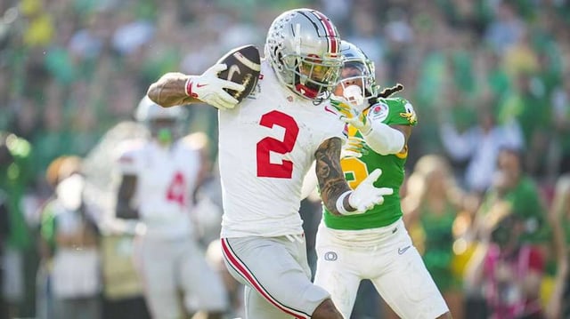 Ohio State Buckeyes wide receiver Emeka Egbuka (2) catches a touchdown in front of Oregon Ducks defensive back Brandon Johnson (3) during the first half of the College Football Playoff quarterfinal at the Rose Bowl in Pasadena, Calif. on Jan. 1, 2025.