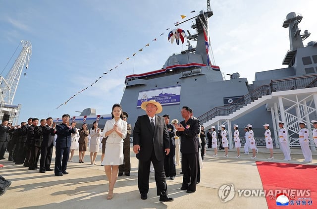 North Korean leader Kim Jong-un (C), alongside his daughter, known as Ju-ae, attends the launching ceremony of the 5,000-ton destroyer Kang Kon at a shipyard in the northeastern city of Rajin on June 12, 2025, 23 days after its first launch attempt, in this photo released by the North's official Korean Central News Agency the next day. (For Use Only in the Republic of Korea. No Redistribution) (Yonhap)