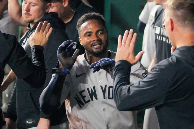 Jun 12, 2025; Kansas City, Missouri, USA; New York Yankees second baseman Pablo Reyes (19) is congratulated in the dugout against the Kansas City Royals after scoring in the eighth inning at Kauffman Stadium. Mandatory Credit: Denny Medley-Imagn Images
