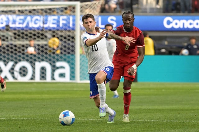 Mar 23, 2025; Inglewood, California, USA; United States of America forward Christian Pulisic (10) kicks th eblal past Canada midfielder Ismael Kone (8) in the first half during the Concacaf Nations League third place match at SoFi Stadium. Mandatory Credit: Jayne Kamin-Oncea-Imagn Images/File Photo
